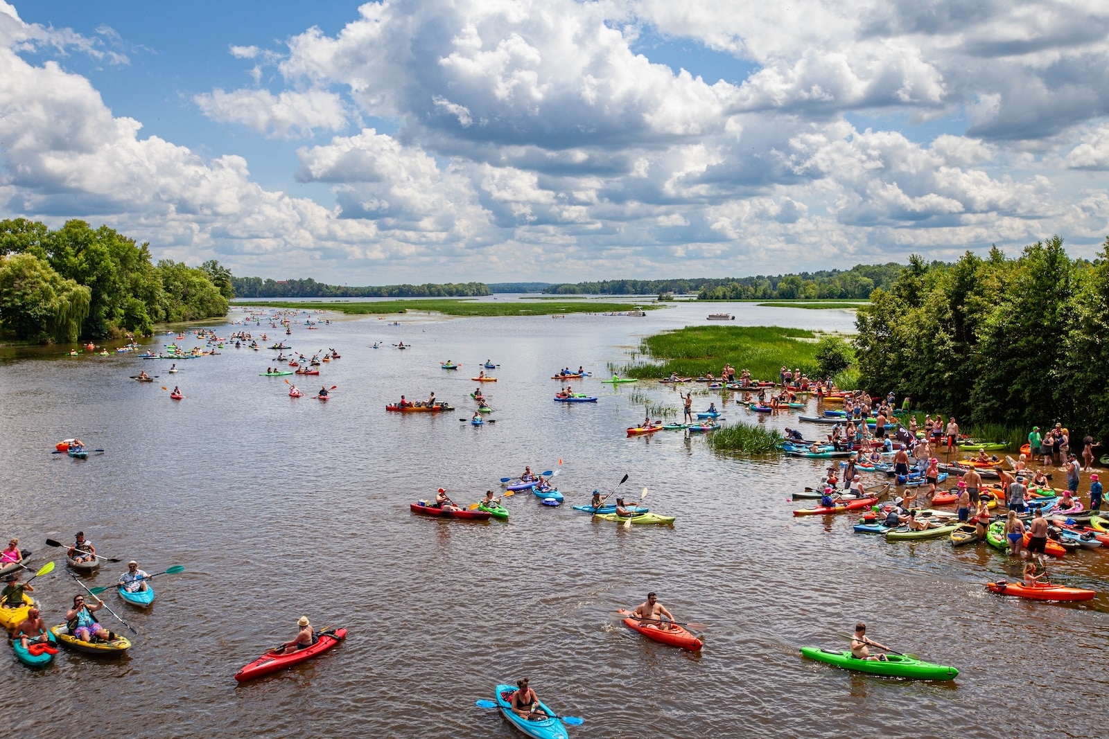 Paddlers at the Paddle Pub Crawl kayaking in downtown Wausau. Many kayakers gathered together in the Wisconsin River. 