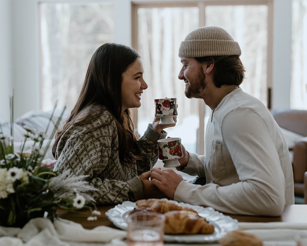 Young couple enjoying a cup of coffee at one of the most romantic getaways in Wisconsin