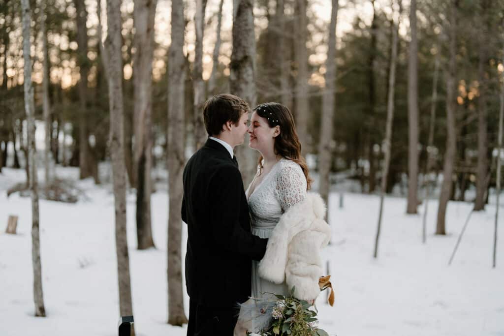 A young couple in the snow during their intimate wedding and elopement at our cabin in Wisconsin