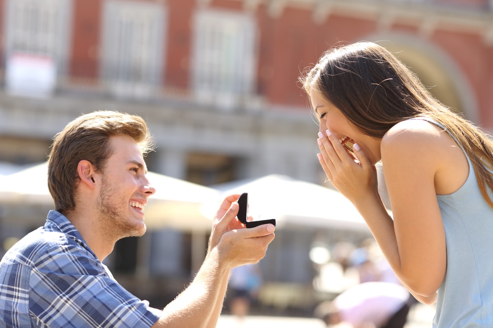 Young couple getting engaged while enoying a romantic trip to one of the best cabins in Wisconsin