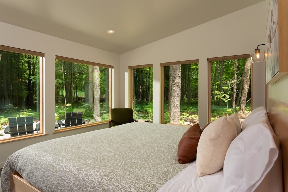 Bedroom overlooking the woods - one of the many reasons we're rated one of the top romantic cabins in Wisconsin